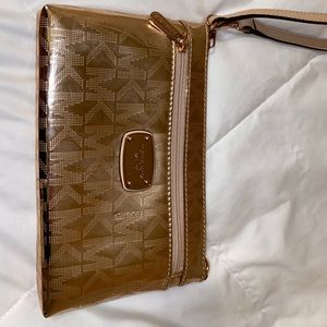Michael Kors rose gold wristlet. Never used.